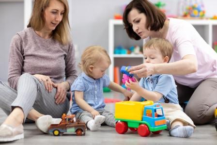 Happy Mothers With Their Babies Play In Nursery